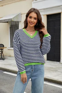Detailed view of stylish striped V-neck sweater with vibrant neon green contrast trim.