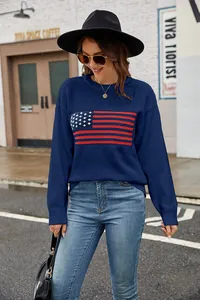 Close-up of a model wearing a navy blue knit sweater with an American flag graphic