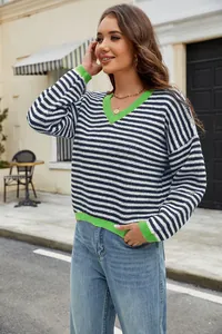 Detail of casual striped knit sweater with vibrant green V-neck and contrast cuffs