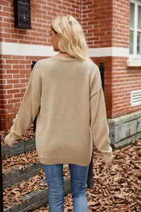 Back view of a casual beige oversized knit sweater with floral crochet sleeves.