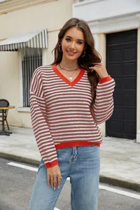 Fashionable women's casual striped knit sweater with orange V-neck in street setting