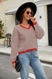 Casual women's striped V-neck pullover sweater featured in an outdoor street setting.