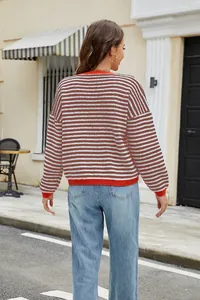 Rear view of women's casual striped knit sweater with orange contrast ribbed hem