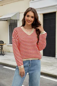Detail view of a casual red and white striped V-neck knitted sweater on a female model