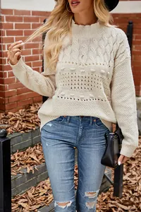 Close-up detail of beige cable knit sweater featuring cozy hollow out pattern for autumn