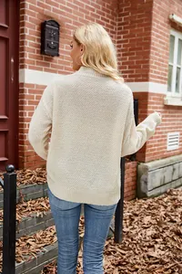 Back view of a cozy cream textured knit sweater for women in an outdoor autumn setting.