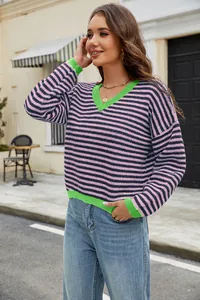 Detailed view of the vibrant striped knit sweater with its contrasting green V-neckline
