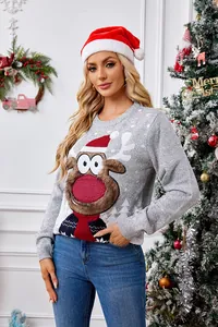 Woman wearing festive grey reindeer Christmas sweater in a cozy holiday home setting indoors