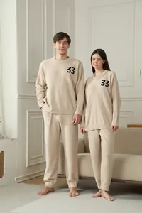 Detail view of soft beige fleece couple loungewear set featuring number 33 embroidery