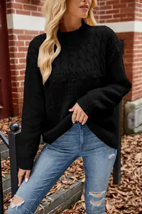 Close-up detail of a classic black cable-knit long sleeve pullover sweater for women