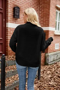 Rear view of a stylish black long-sleeved knitted pullover sweater in an outdoor setting
