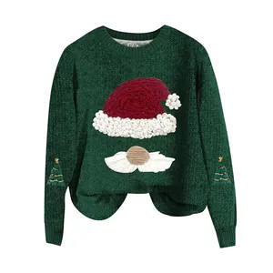 Close-up of green knitted Christmas sweater with Santa hat and tree embroidery details.