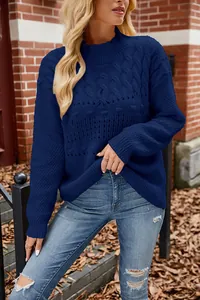 Close-up detail of navy blue cable-knit texture on oversized casual sweater
