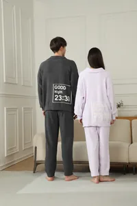 Back view of cozy couple fleece pajama sets featuring 'Good Night' design in home setting