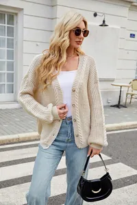Fashionable oversized beige cable knit cardigan sweater for women in a street style look
