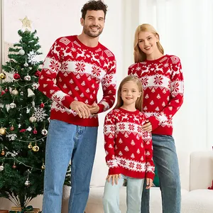 Matching family Christmas sweaters with reindeer and snowflake jacquard patterns in a cozy home setting.