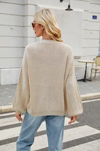Detailed back view of a cream oversized knit sweater featuring ribbed lantern sleeves texture