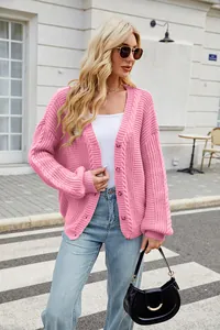 Detailed view of stylish women's pink loose cable knit cardigan sweater with buttons
