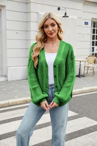 Detailed macro shot of the green V-neck cable knit sweater cardigan with front buttons