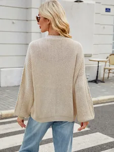 Back view of an oversized beige chunky knit sweater with balloon sleeves for women