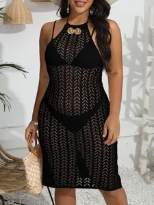 Elegant black crochet beach dress featuring intricate hollow patterns and a gold butterfly buckle.