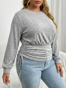 Detail of grey plus size long sleeve top with adjustable drawstring waist.