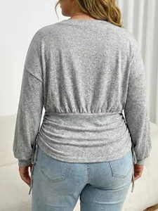 Detailed back view of a grey plus size marled knit top featuring adjustable drawstring waist