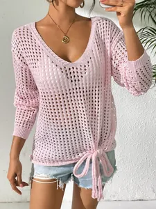 Detailed view of women's pink V-neck hollow-out knit top featuring a chic tie-knot hem