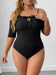 Detailed view of a plus-size black ribbed bodysuit with an off-the-shoulder strap design.