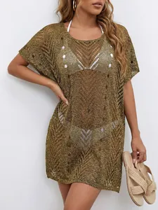 Detail showing gold shimmering metallic knit texture on a sexy beach bikini cover-up