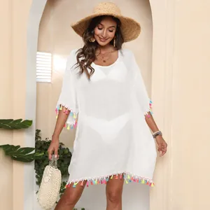 Robe de plage blanche avec pompons colorés pour les vacances d'été au bord de l'eau