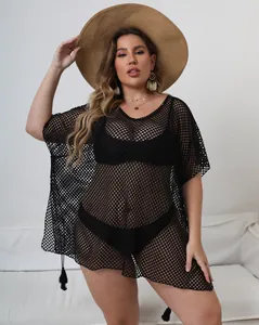Detail view of plus size black mesh beach cover up with tassel hem