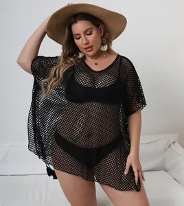 Close-up of black mesh beach cover-up showing intricate see-through fishnet texture.