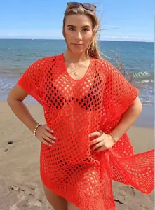 Red hollow knit crochet beach cover-up with V-neckline shown on model at the beach