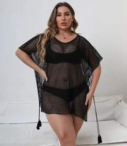Detailed view of a black plus-size mesh beach cover-up with irregular hem and tassel detail.
