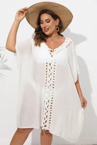 Close-up detail of the hand-crocheted hollow-out pattern on this white beach kaftan cover-up