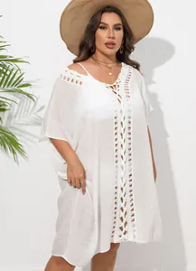 Macro view of exquisite white crochet lace stitching on the loose summer beach dress