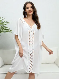 Elegant white crochet lace beach cover-up dress with intricate hollow-out front detailing