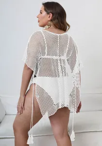 Detail view of white plus-size mesh beach cover-up with tassel hem and back perspective.