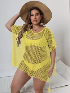 Detail view of plus size yellow mesh beach cover-up with irregular hem design
