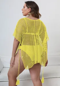 Detail shot of yellow plus size mesh beach cover-up featuring tassels and sexy open weave