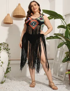 Close-up of handmade crochet beach cover-up with long tassels and vibrant patterns.