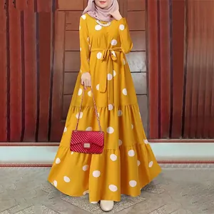 Full detailed view of a yellow vintage polka dot maxi dress with a tiered skirt design.