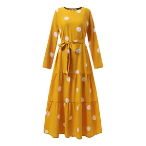 Yellow long-sleeve maxi dress with large white polka dot print and waist tie belt