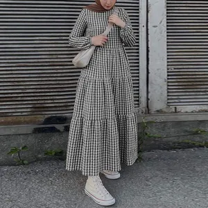 Full view of a stylish black and white gingham puff sleeve tiered maxi dress.