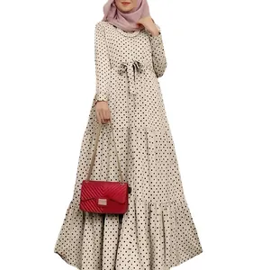 Elegant beige long sleeve polka dot maxi dress featuring a matching bow belt detail.