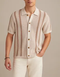 Detail view of men's beige mesh knit polo shirt with stripes and button closure.