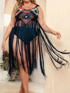 Stylish plus size crochet beach cover-up featuring ethnic patterns and long black tassels