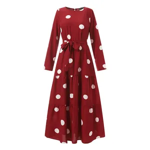 Elegant vintage red polka dot maxi dress featuring long sleeves and a belted waist design.