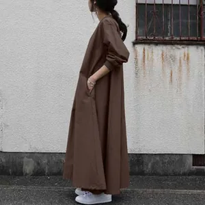 Side view of a dark brown loose-fit long sleeve maxi dress showing fabric and drape